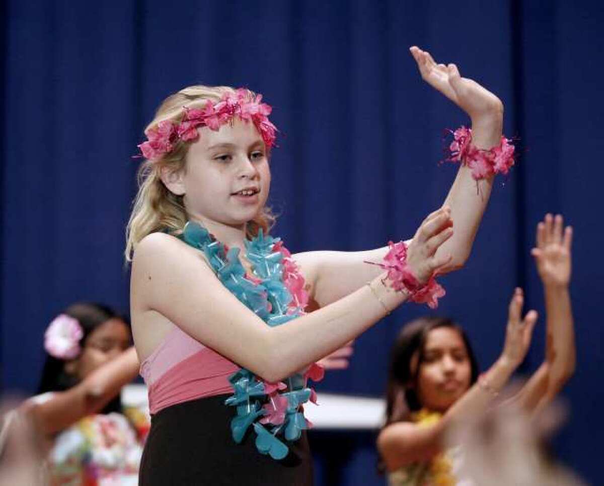 Abigail Powell dances to a Hawaiian song along with other members of the Hula Club during a performance of "Making A Difference With The Aloha Spirit" at Roosevelt Elementary School in Burbank.