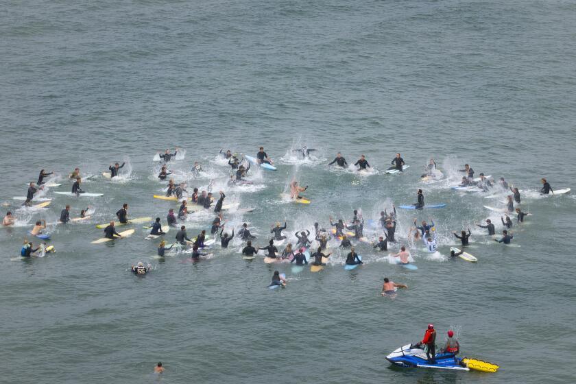 San Diego, CA - May 11: Dozens of surfers gathered in Ocean Beach on Saturday, May 11, 2024 in San Diego, CA, for a memorial paddle out for Callum Robinson, one of the three surfers killed in Mexico. (Nelvin C. Cepeda / The San Diego Union-Tribune)