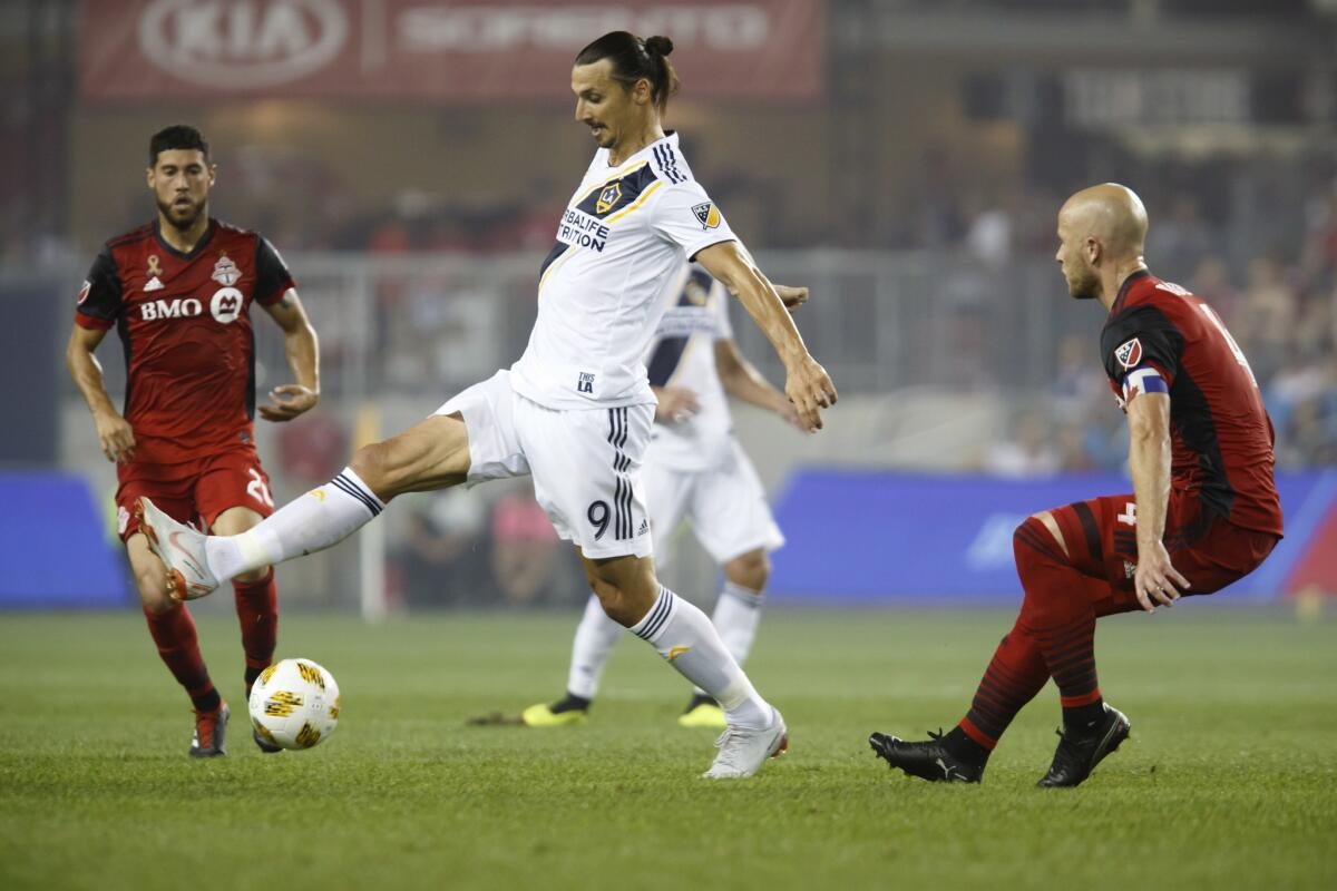 Los Angeles Galaxy forward Zlatan Ibrahimovic (9) controls the ball against Toronto FC midfielder Michael Bradley (4) during the first half of an MLS soccer game, Saturday, Sept. 15, 2018 in Toronto.