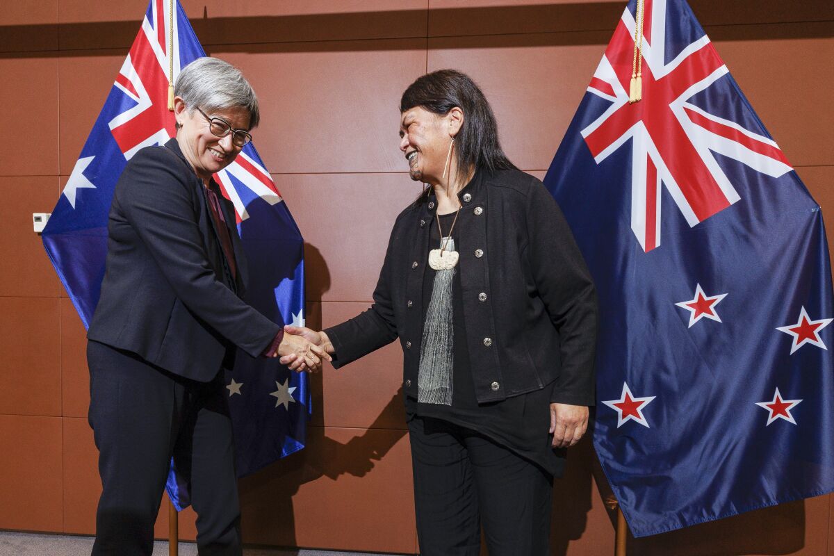 Australian Foreign Minister Penny Wong, left, is welcomed to Parliament House by New Zealand Foreign Minister Nanaia Mahuta ahead of a bilateral meeting in Wellington, New Zealand, Thursday, June 16, 2022. (Robert Kitchin/Pool Photo via AP)