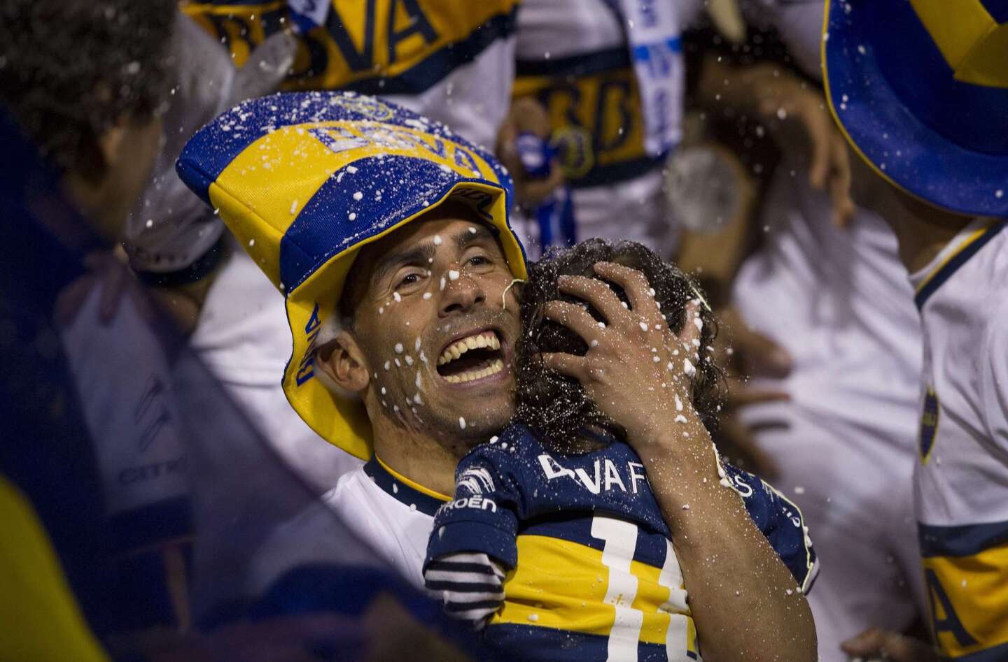 Boca Juniors' forward Carlos Tevez celebrates while holding his son after winning Argentina's first division football championship at the "La Bombonera" stadium in Buenos Aires, on November 1, 2015. AFP PHOTO / ALEJANDRO PAGNIALEJANDRO PAGNI/AFP/Getty Images ** OUTS - ELSENT, FPG, CM - OUTS * NM, PH, VA if sourced by CT, LA or MoD **
