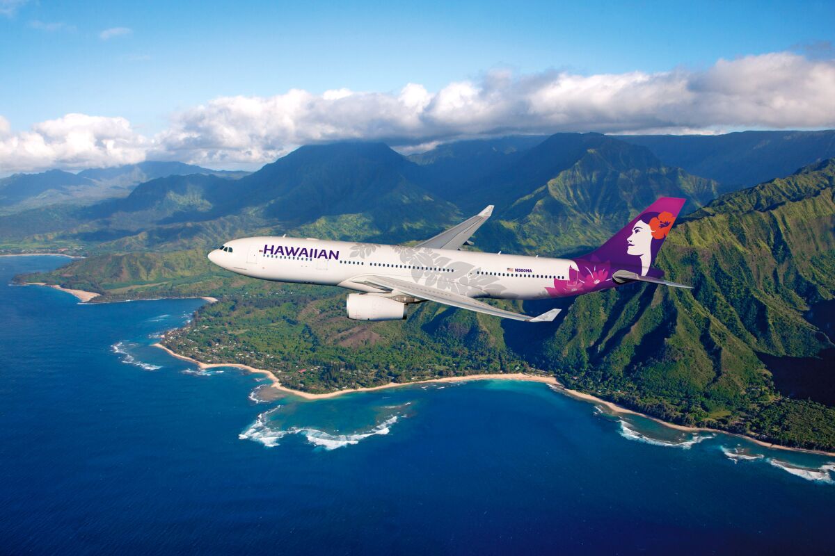 A Hawaiian airlines A330 flies over the islands.