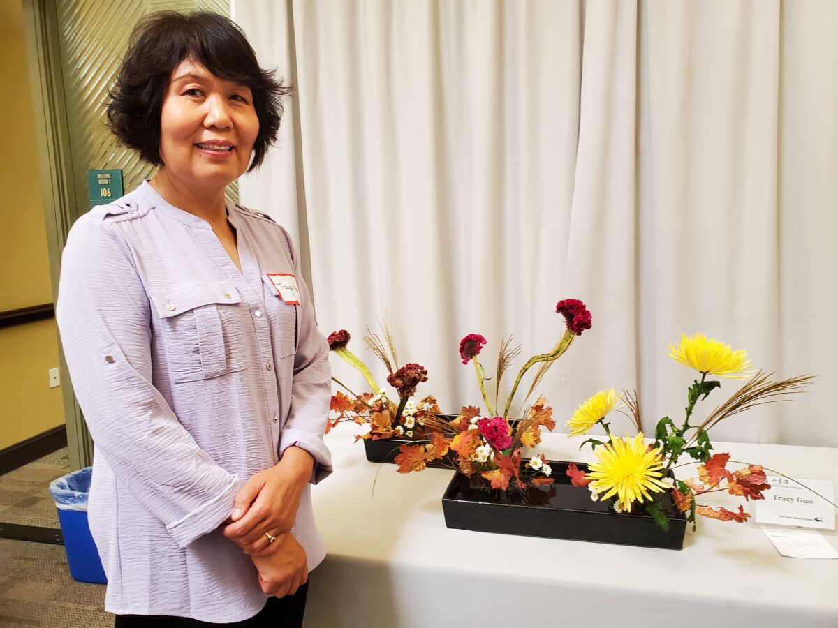 Current San Diego Sakura Chapter of the Ohara School of Ikebana President Tracy Guo with her arrangement.