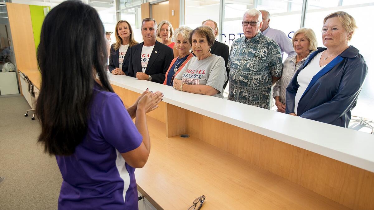 Leilani Brown, the city clerk for Newport Beach, explains to a group of people who want to recall Newport Beach City Councilman Scott Peotter the process to count the petitions at City Hall in 2017.