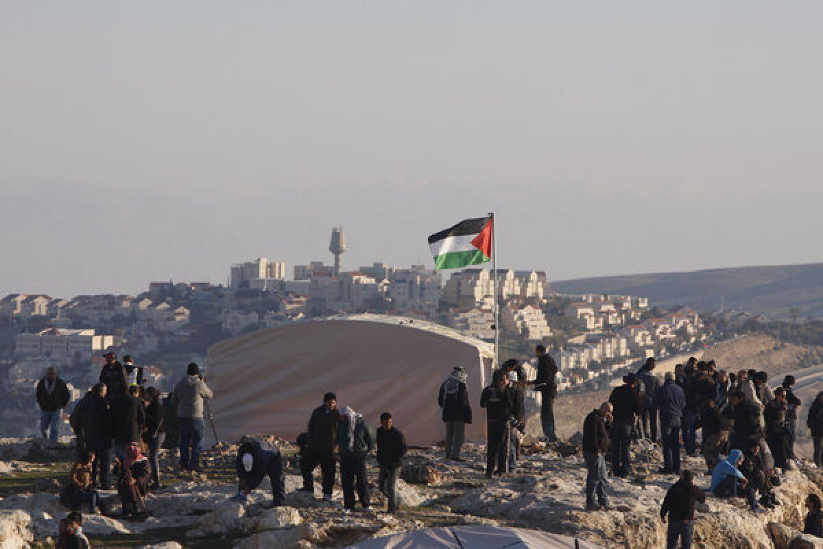 Activists protesting a planned Israeli development gather at a tent village before it was dismantled by Israeli police on Sunday.