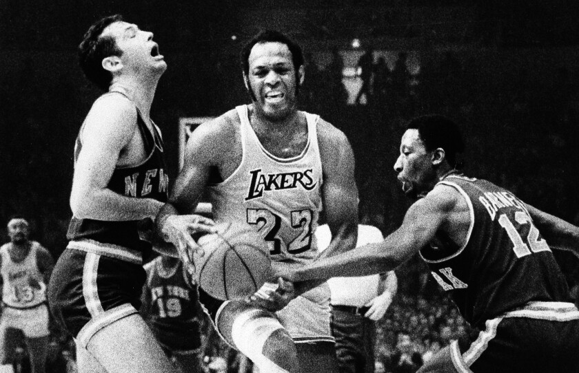 Los Angeles Lakers' Elgin Baylor maneuvers his way through New York Knicks' Bill Bradley