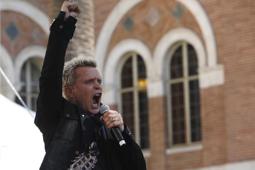 Billy Idol, author of "Dancing with Myself," performs a song after speaking about his book at the Los Angeles Times Festival of Books on the USC campus.