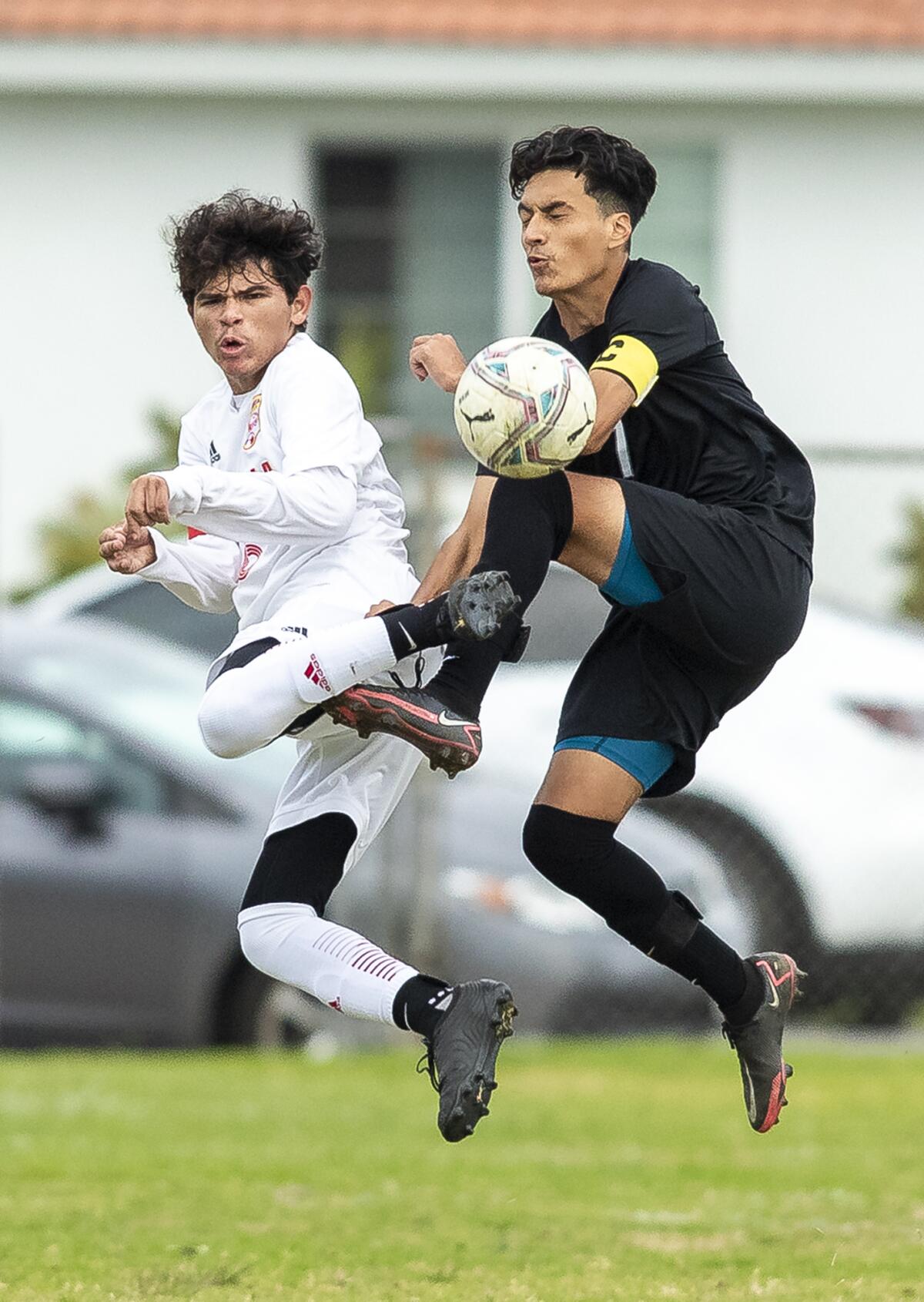Estancia's Cruz Valdovinos and Los Amigos' Federico Betancourt go up for a ball during a nonleague boys' soccer match.
