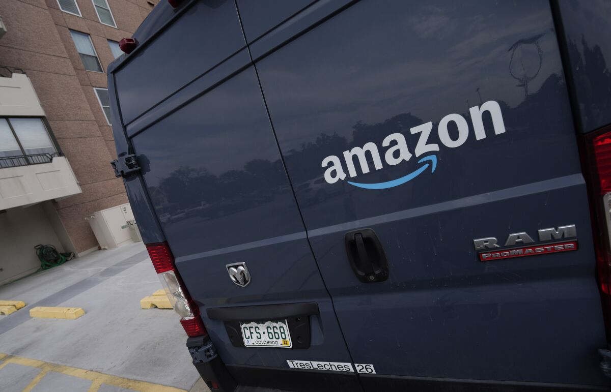 FILE - The company logo graces one of the doors of a delivery van for Amazon Wednesday, Sept. 1, 2021, in Denver. Amazon said Wednesday, April 13, 2022 it will add a 5% “fuel and inflation surcharge” to fees it charges third-party sellers who use the retailer’s fulfillment services as the company faces rising costs. The company said in an announcement on its website that the added fees will take effect on April 28 and are subject to change. Federal data released Tuesday showed inflation hit 8.5% in March, its fastest pace in more than 40 years. (AP Photo/David Zalubowski, file)