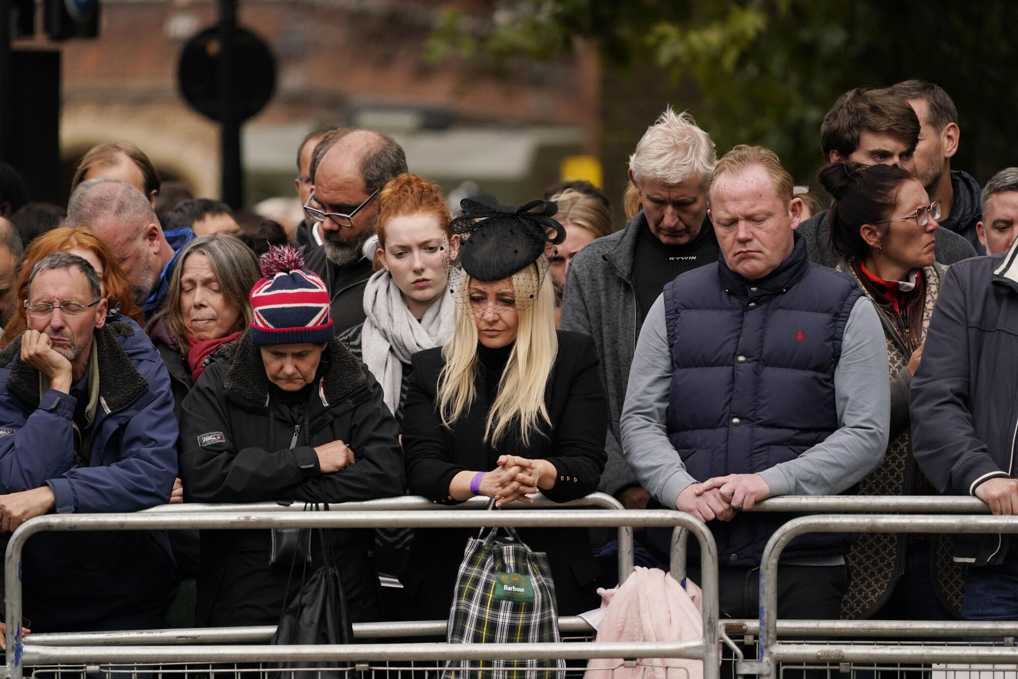 Members of the public listen to the funeral service of Queen Elizabeth II in central London on Monday.