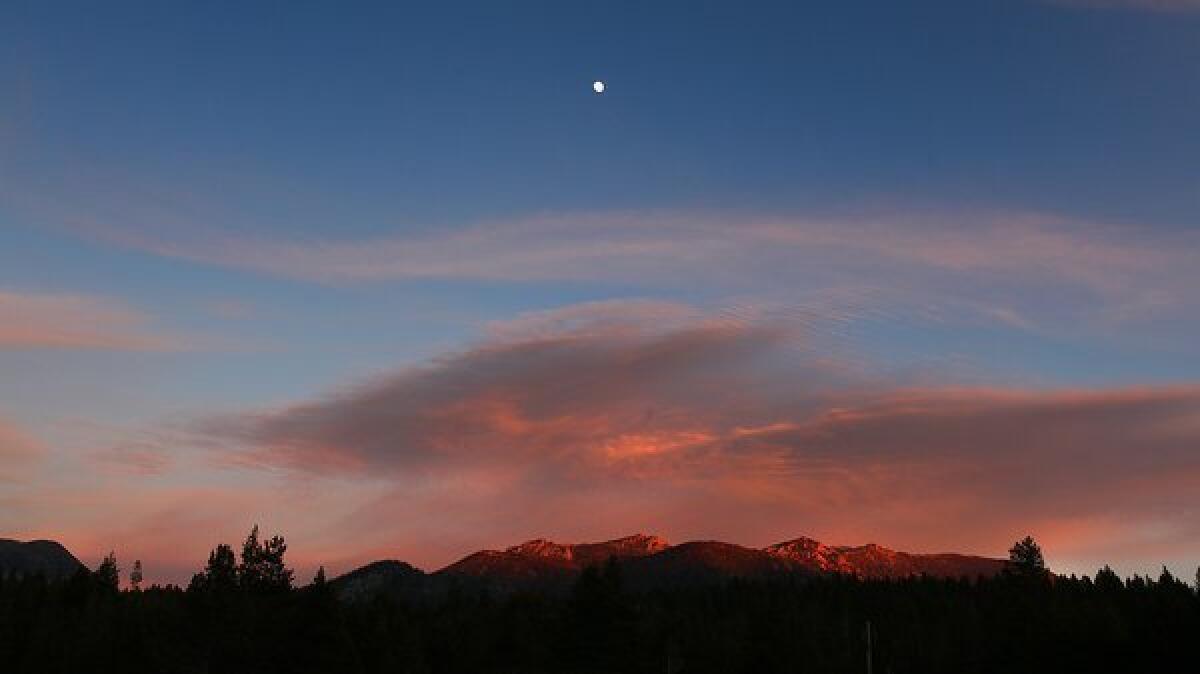 The moon rises above Sierra Nevada peaks near South Lake Tahoe.