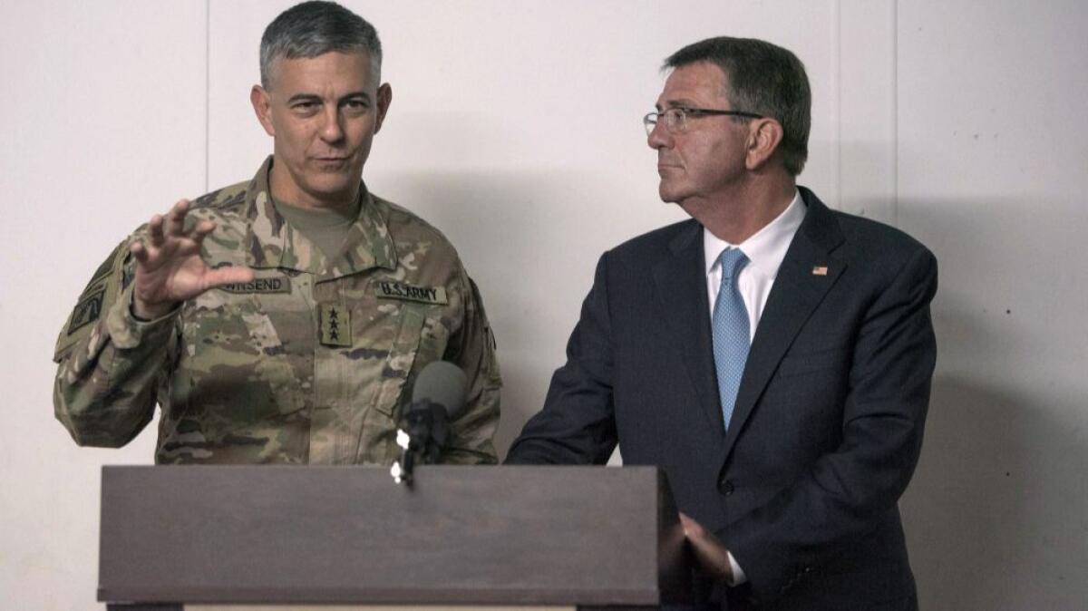 Defense Secretary Ashton Carter listens as U.S. Army Lt. Gen. Stephen Townsend, commander of Combined Joint Task Force-Operation Inherent Resolve, speaks during a news conference in Irbil, Iraq, on Oct. 23, 2016.