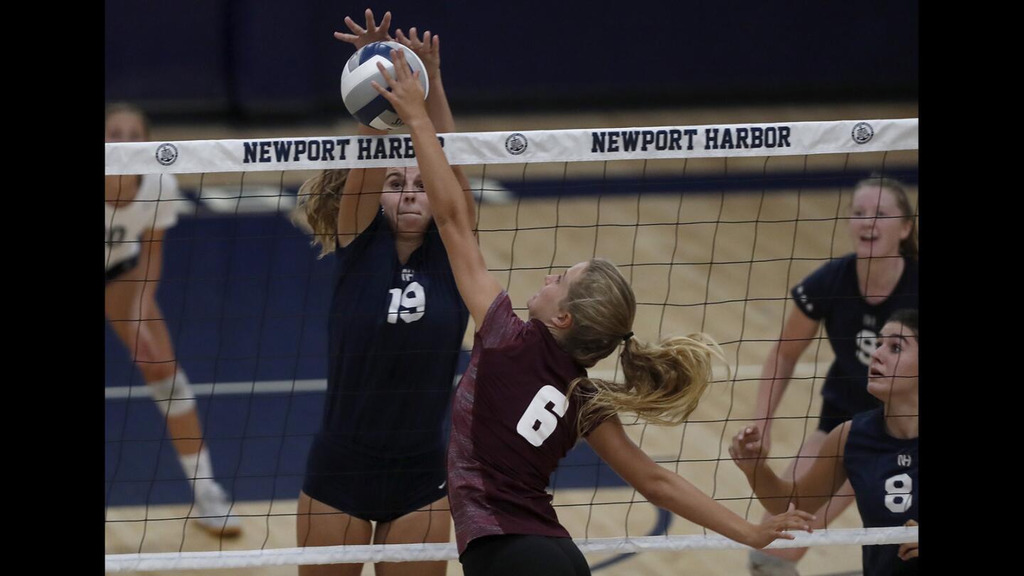 Newport Harbor High's Siena Springborn (19) battles Laguna Beach's Natalia Hagopian (6) at the net during the second set in a Wave League match at Newport Harbor High on Wednesday, Sept. 26.