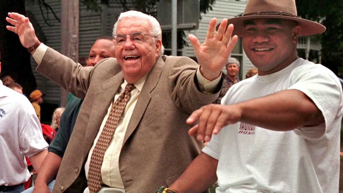 Lou Duva, left, acknowledges the crowd alongside Dave Tua during the Parade of Champions before his induction ceremony into the International Boxing Hall of Fame on June 14, 1998, in Canastota, N.Y.