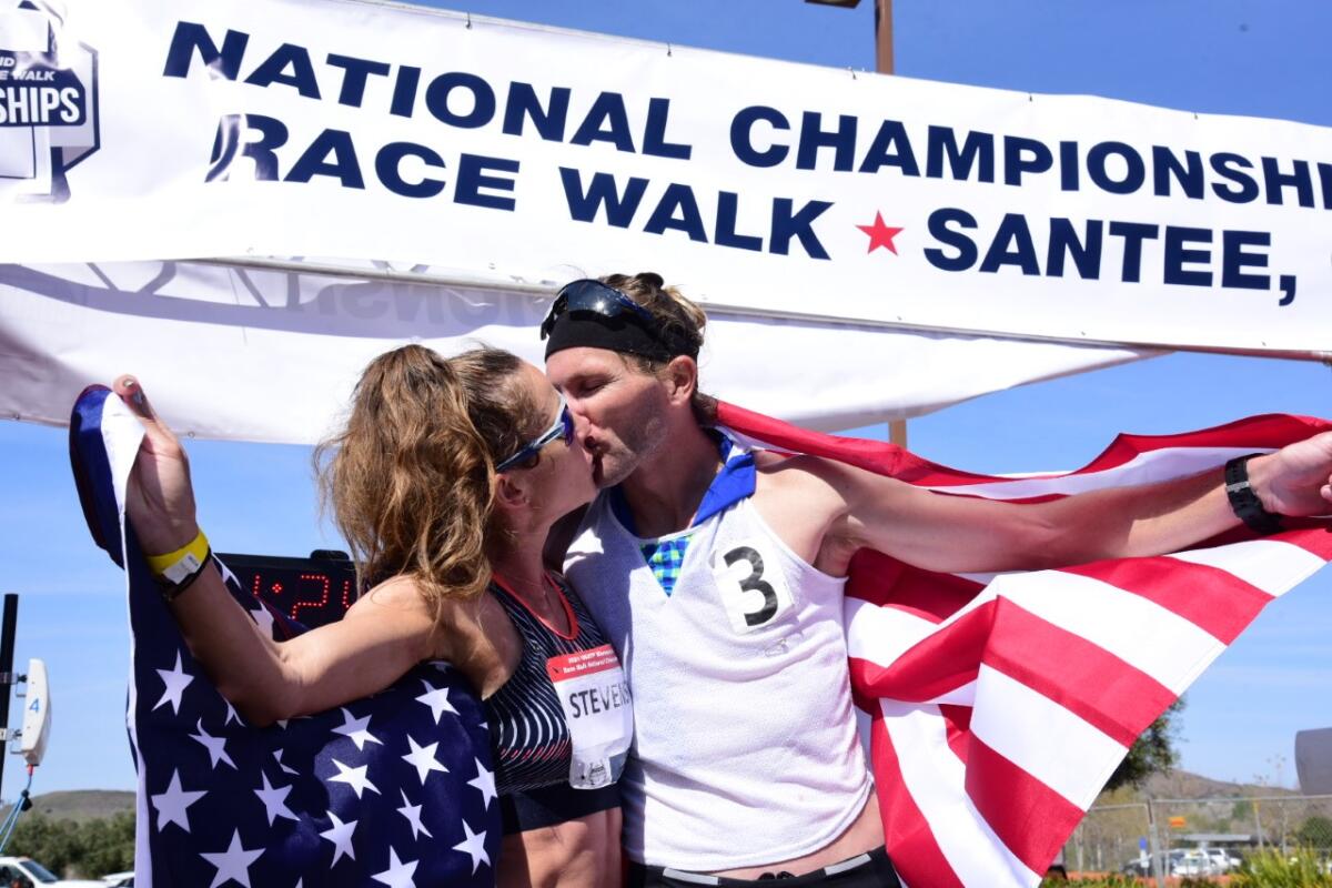 Robyn Stevens and Nick Christie, national race walk championship winners, share a buss at the end of the Santee competition.