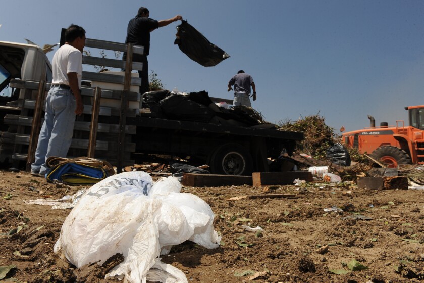 Work crews dump trash at the Scholl Canyon landfill in Los Angeles last June.