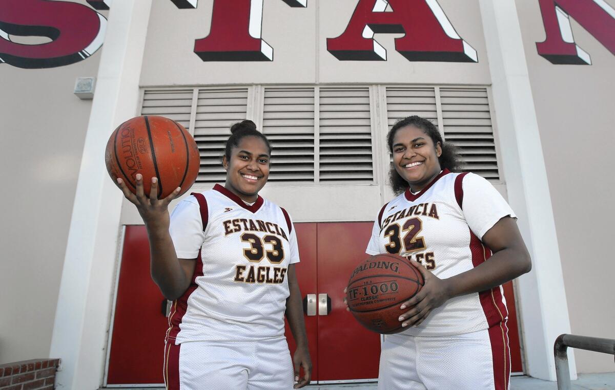 Nefertiti Van Den Heever, left, and twin sister Maya are both senior starters and leaders for the Estancia High girls' basketball team.