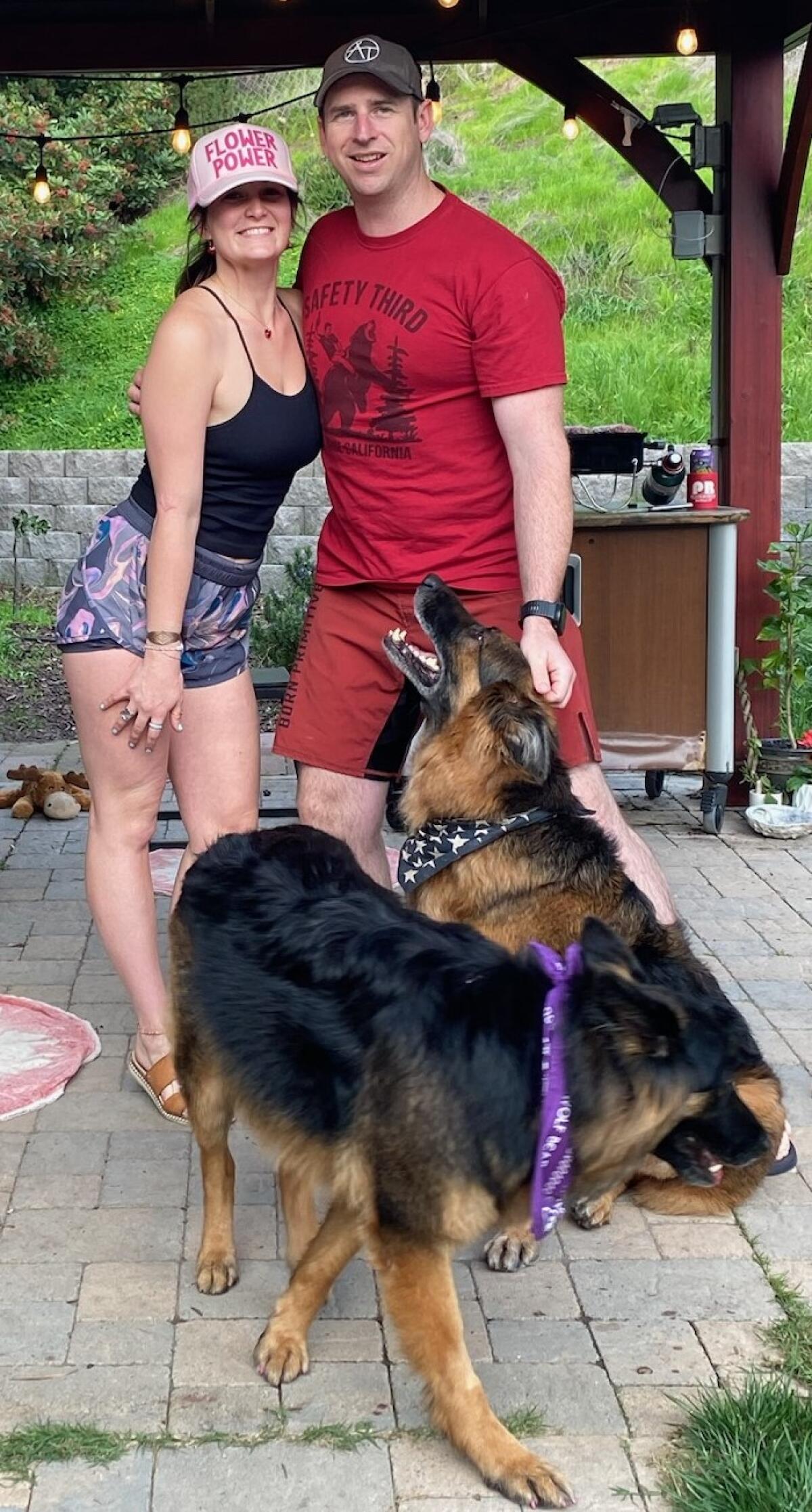Groomer Ashley Montague and her husband, Eric, spend time with their two German shepherds.