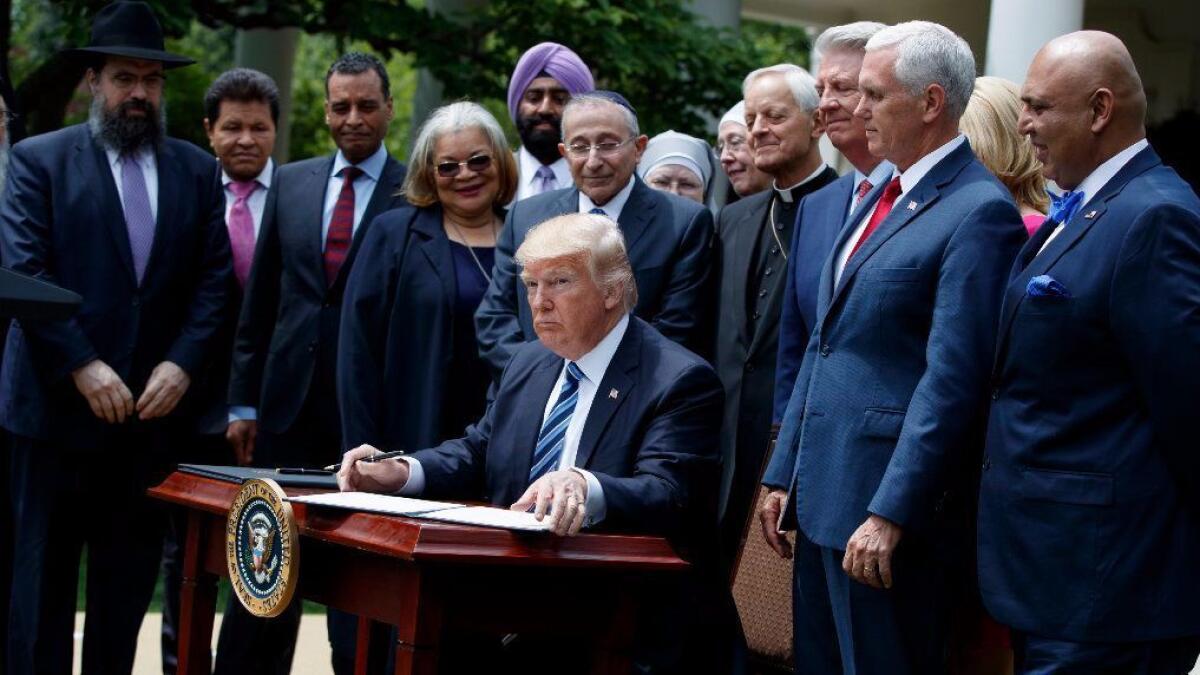 President Trump signs an executive order aimed at easing an IRS rule limiting political activity for churches.