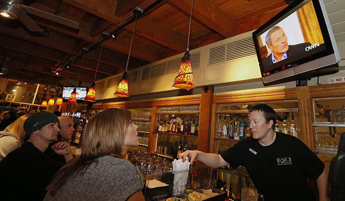 Patrons in Park City, Utah, watch Lance Armstrong's interview with Oprah Winfrey.