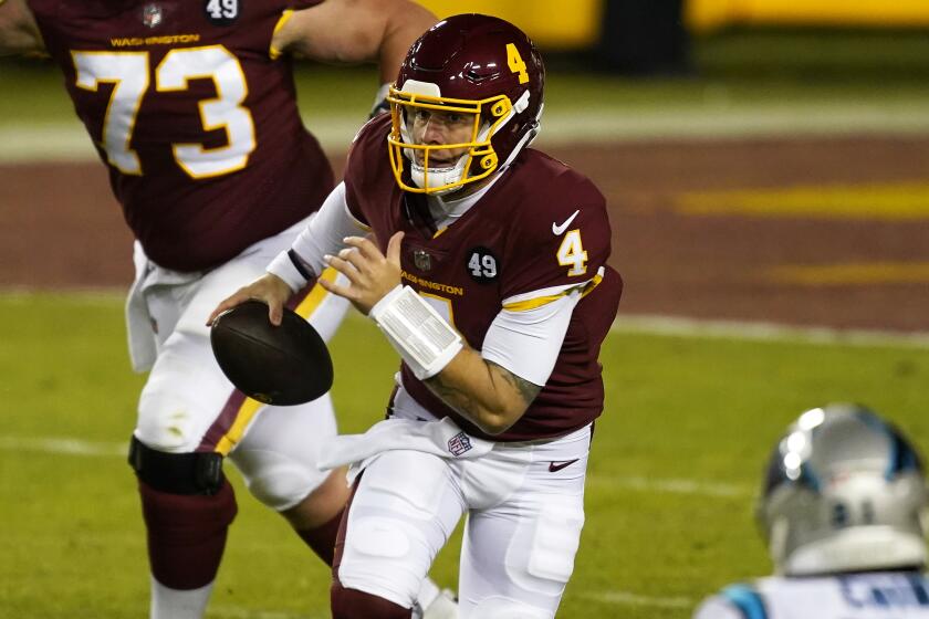 Washington Football Team quarterback Taylor Heinicke scrambles during an NFL football game.