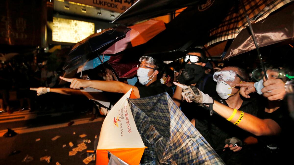Pro-democracy protesters shout at police in the Mong Kok district of Hong Kong