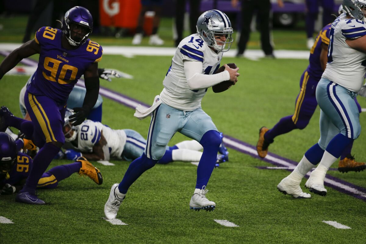 Dallas Cowboys quarterback Andy Dalton scrambles against the Minnesota Vikings.
