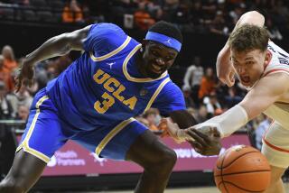 Oregon State forward Tyler Bilodeau (34) knocks the ball away from UCLA forward Adem Bona (3) during the second half of an NCAA college basketball game Thursday, Dec. 28, 2023, in Corvallis, Ore. (AP Photo/Mark Ylen)