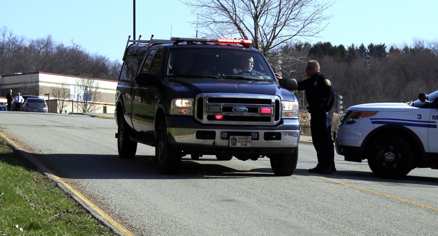 Emergency responders gather in the parking lot at Franklin Regional Schools, where at least 20 people were injured in a mass stabbing at the senior high school on Wednesday.