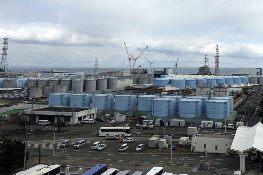 FILE - This photo shows some of about 1,000 huge tanks holding treated but still radioactive wastewater at the Fukushima Daiichi nuclear power plant, operated by Tokyo Electric Power Company Holdings (TEPCO), in Okuma town, northeastern Japan, on Feb. 22, 2023. An International Atomic Energy Agency team arrived in Tokyo on Monday, May 29, 2023, for a final review before Japan begins releasing massive amounts of treated radioactive water into the sea from the wrecked Fukushima nuclear plant, a plan that has been strongly opposed by local fishing communities and neighboring countries. (AP Photo/Mari Yamaguchi, File)