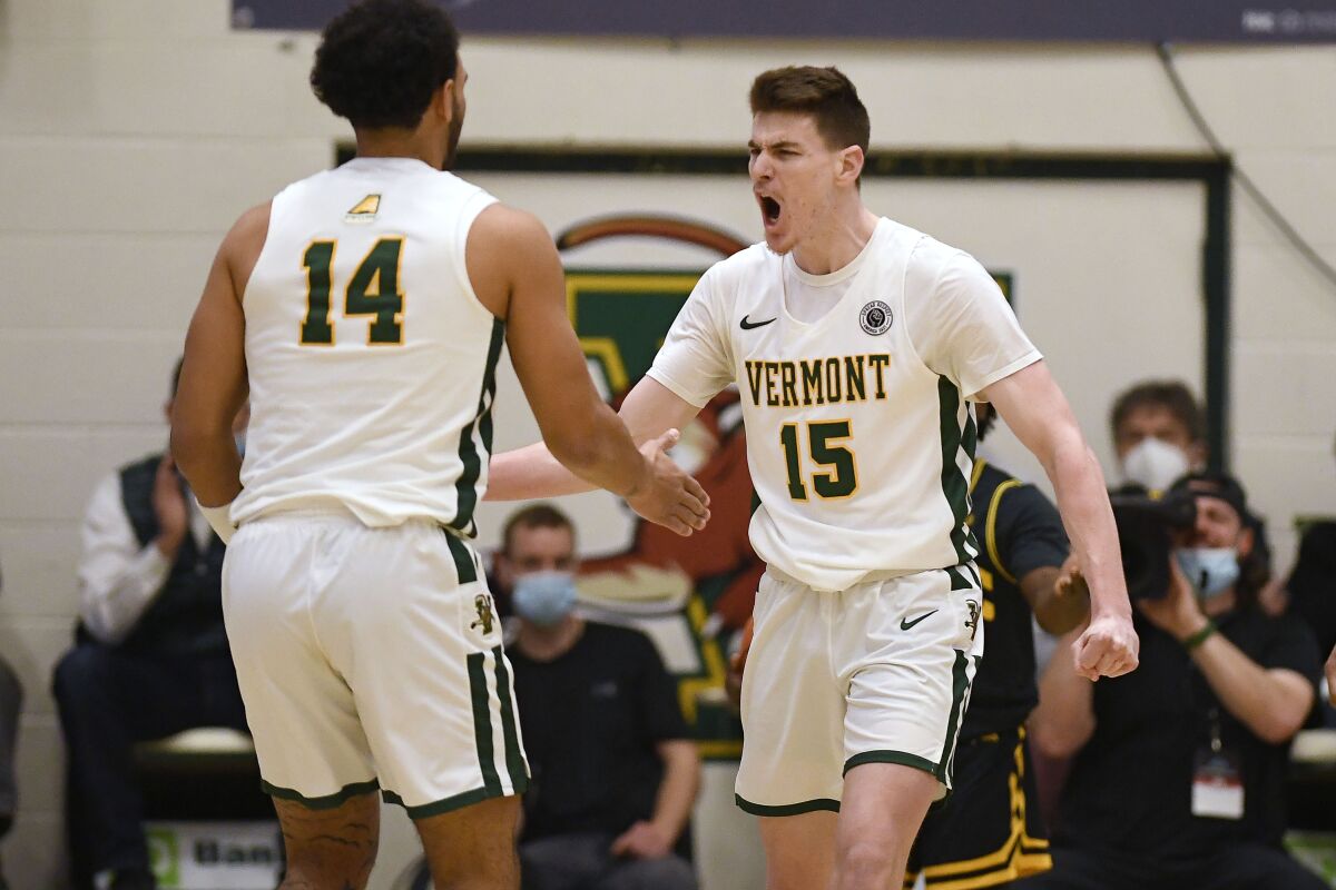 Vermont's Finn Sullivan (15) reacts toward teammate Isaiah Powell (14) during Saturday's America East Conference title game.