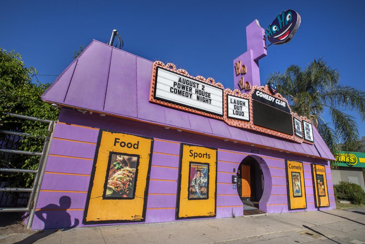 Purple and yellow building with a comedy club marquee
