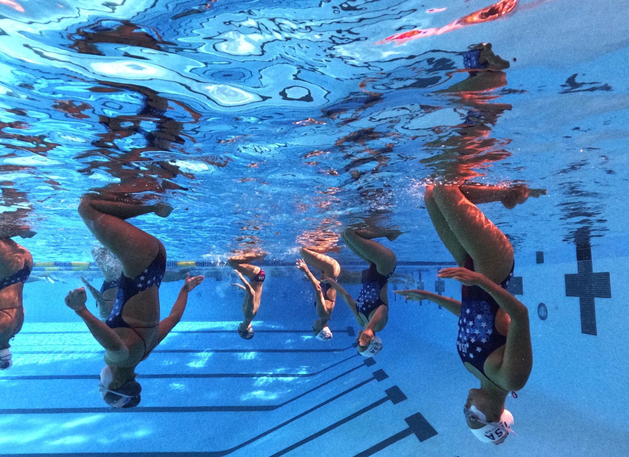 Members of the U.S. Artistic Swimming team, including Calista Liu, right, practice at UCLA.