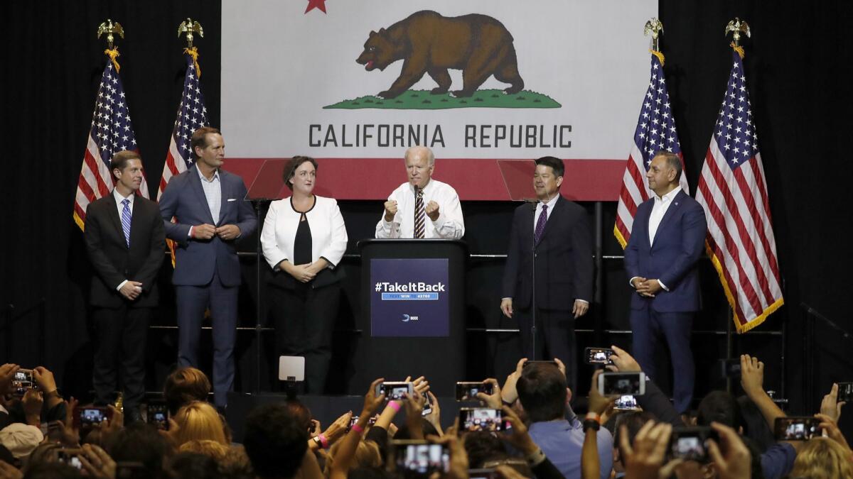 Former Vice President Joe Biden, center, with Democratic House candidates Mike Levin, left, Harley Rouda, Katie Porter, TJ Cox and Gil Cisneros at Cal State Fullerton.