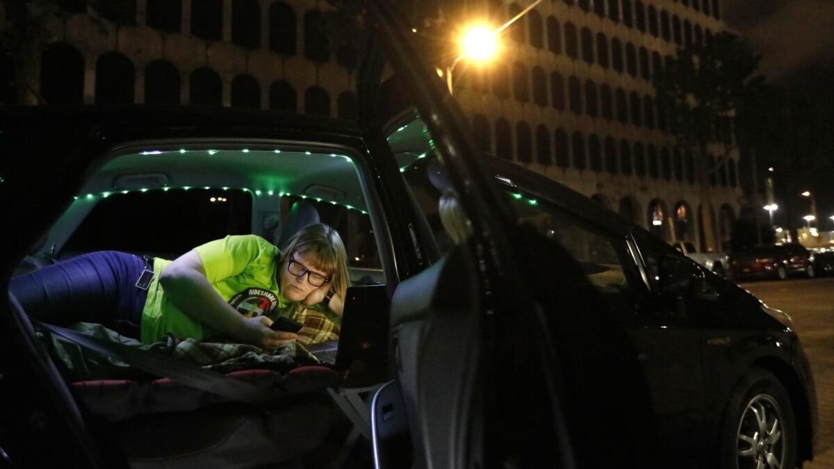 At 1 a.m. Jos Cashon, 28, works on social media to promote a one-day strike against Uber and Lyft before bedding down for the night in her car.