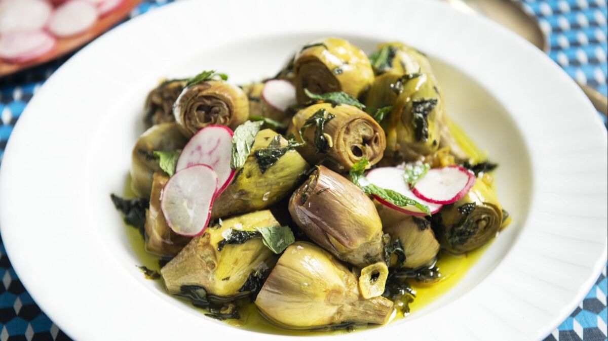 Fresh radish slices add crunch to baby artichokes slow-cooked in olive oil and herbs.