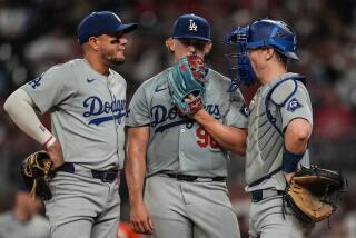 Los Angeles Dodgers pitcher Landon Knack (96) speaks with catcher Will Smith.