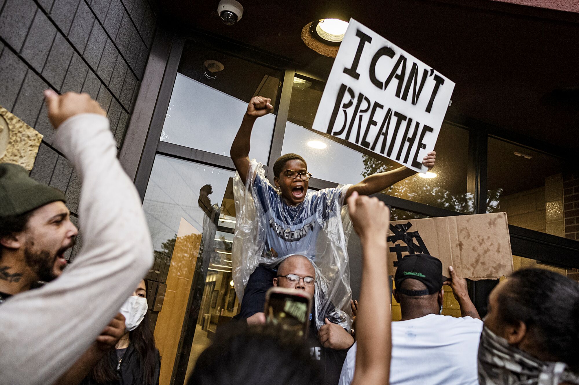 People gather at a Minneapolis police precinct during a protest May 26 after the death of George Floyd, who told the officer kneeling on his neck that he couldn't breathe.