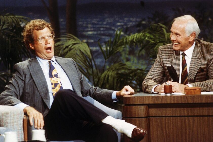 "Late Night with David Letterman" host David Letterman, left, appears with host Johnny Carson during a taping of "The Tonight Show" in 1991.