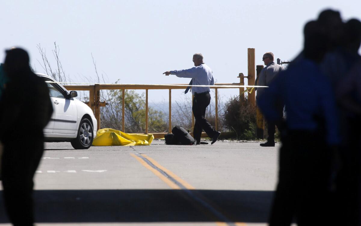 Investigators at the scene Tuesday of a fatal shooting at the Las Pulgas Road off-ramp from the southbound 5 Freeway near Camp Pendleton. A 55-year-old man from Vista was shot by deputies and Border Patrol agents.