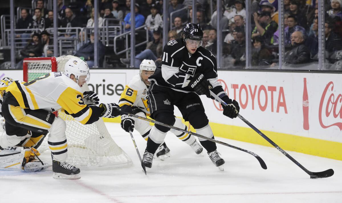 Kings' Anze Kopitar is defended by Pittsburgh's Olli Maatta, left, and Trevor Daley on Nov. 3.