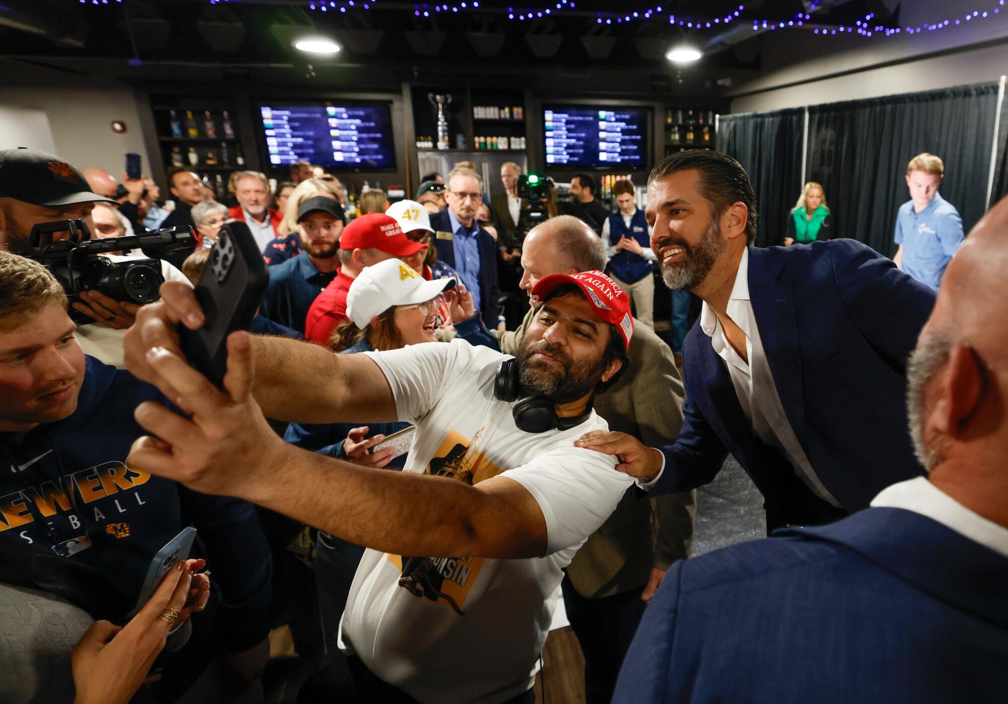 Donald Trump Jr. takes photos with supporters after a town hall meeting M