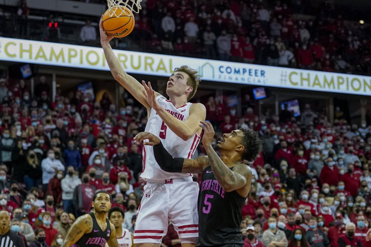 Wisconsin's Tyler Wahl (5) shoots the winning basket against Penn State's Greg Lee (5) during the second half of an NCAA college basketball game Saturday, Feb. 5, 2022, in Madison, Wis. (AP Photo/Andy Manis)