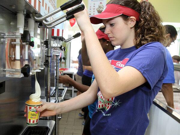 Sarah Terry, 16, of La Canada, fills an order at the grand opening of Rita's Italian Ice in La Canada Flintridge. This is Sarah's first job.
