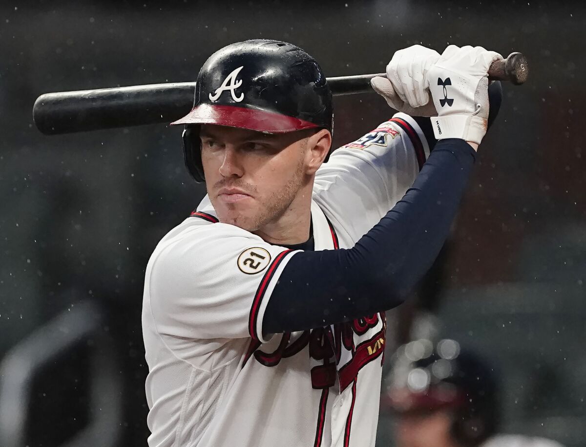 FILE - Atlanta Braves' Freddie Freeman (5) bats during a baseball game against the Colorado Rockies, Sept. 15, 2021, in Atlanta. Freeman, Carlos Correa, and Kris Bryant are among 138 free agents set to resume looking for a spot after a freeze on roster transactions lifts with the signing of baseball's new labor deal. (AP Photo/John Bazemore, File)