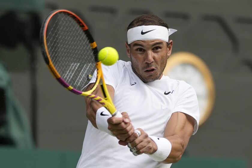 Spain's Rafael Nadal returns the ball to Italy's Lorenzo Sonego at Wimbledon.