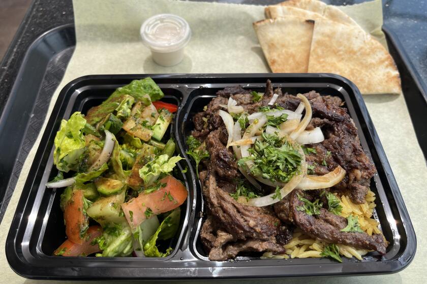 A beef shawarma plate with yellow rice and fattoush salad at La Cocina Mediterranea