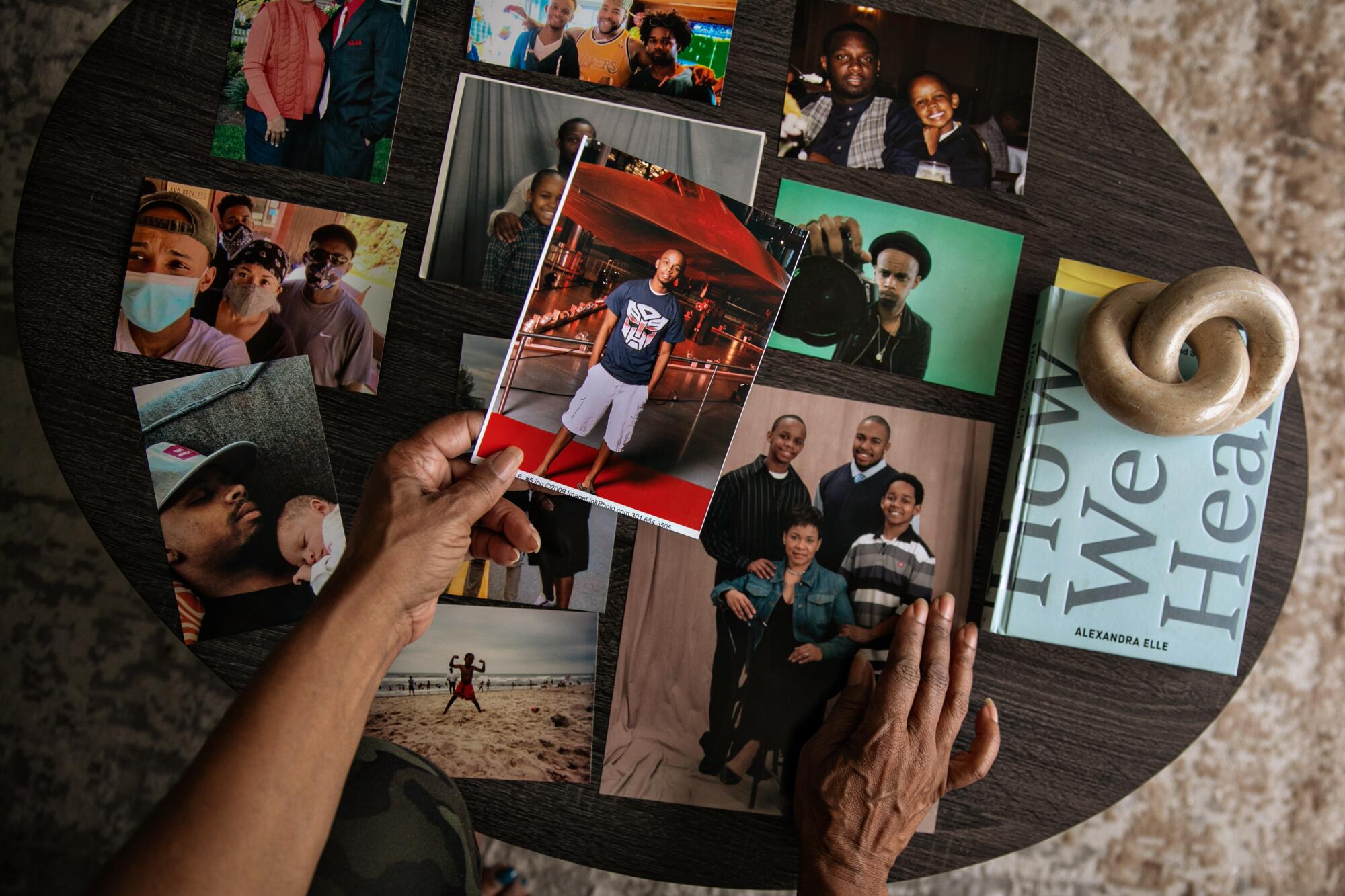 Deneen Vaughn looks at family photos and stops on a photo of her late son Chris