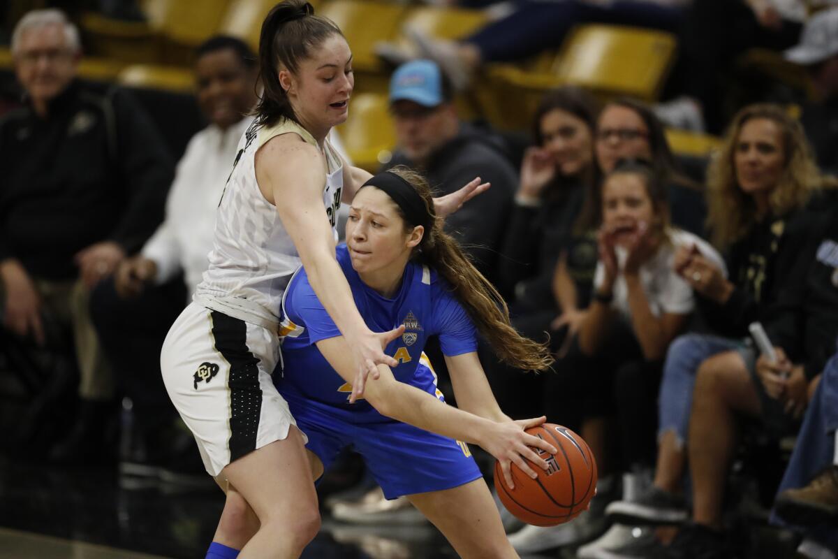 Colorado guard Emma Clarke (3) and UCLA guard Lindsey Corsaro (4) in the second half on Sunday in Boulder, Colo. UCLA won 65-62. 