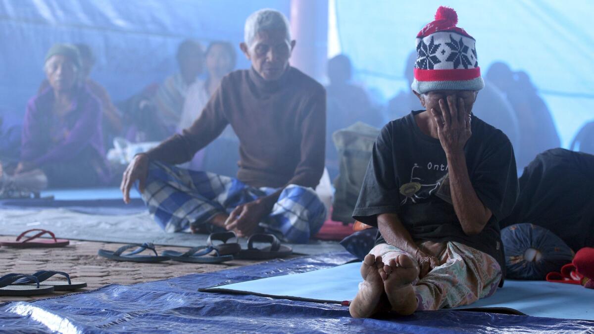 Villagers sit in a temporary shelter in Bali, Indonesia, on Sept. 23, 2017.